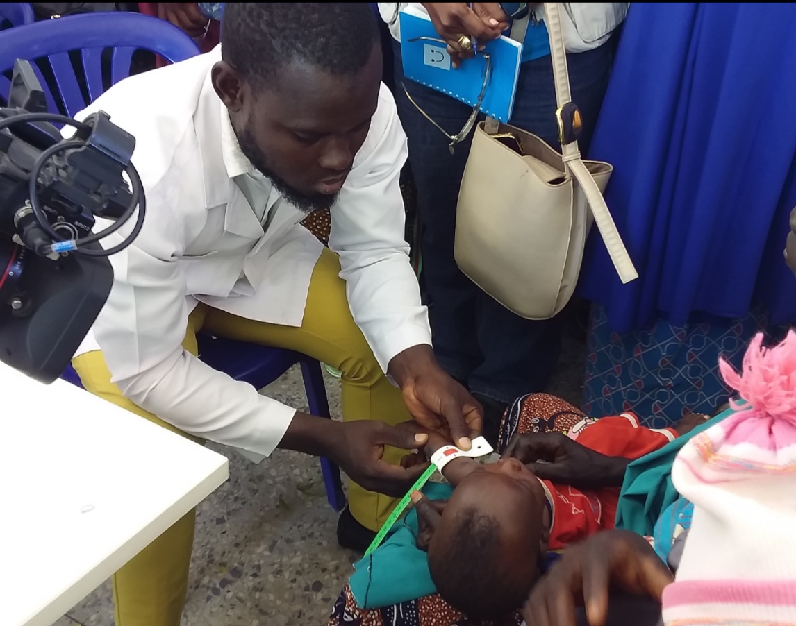 A service provider examining a child at one of the sites.