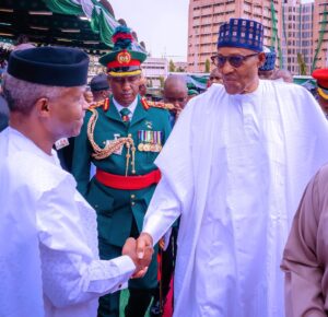 Prof Osinbajo in a handshake with late President Buhari 